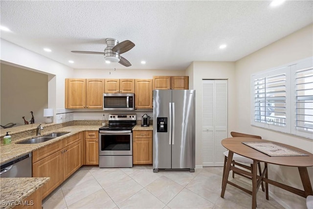 733 Landover Ct Unit 203, Naples, FL 34104 - kitchen featuring light stone counters, a sink, light tile patterned flooring, ceiling fan, and appliances with stainless steel finishes