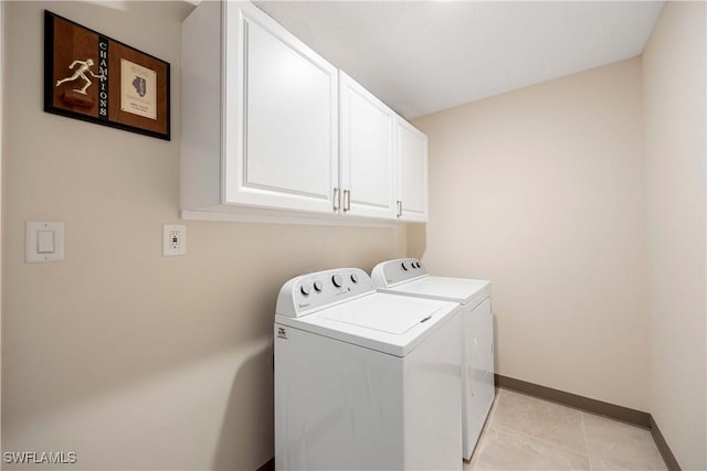 733 Landover Ct Unit 203, Naples, FL 34104 - laundry room with washing machine and dryer, baseboards, cabinet space, and light tile patterned floors