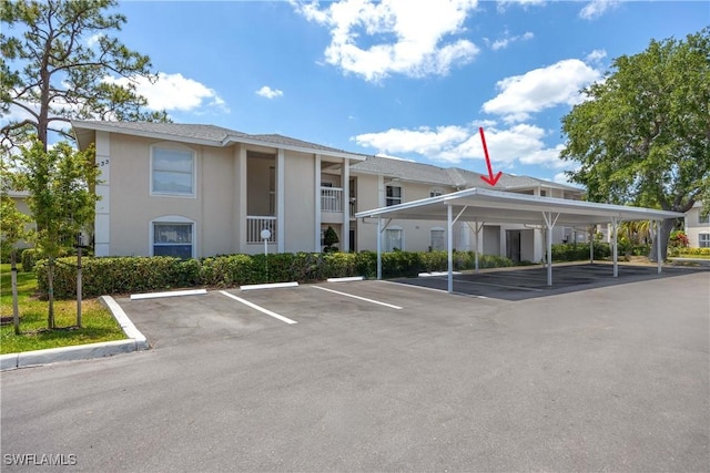 733 Landover Ct Unit 203, Naples, FL 34104 - view of building exterior with covered and uncovered parking