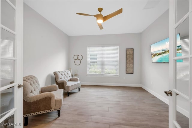 15766 Cortina St, Naples, FL 34114 - living area featuring a ceiling fan, wood finished floors, and baseboards