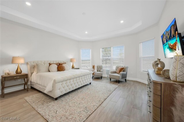 15766 Cortina St, Naples, FL 34114 - bedroom featuring light wood-style floors, a tray ceiling, baseboards, and recessed lighting