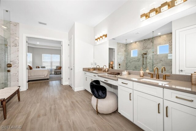 15766 Cortina St, Naples, FL 34114 - bathroom featuring ensuite bathroom, a marble finish shower, vanity, and wood finished floors