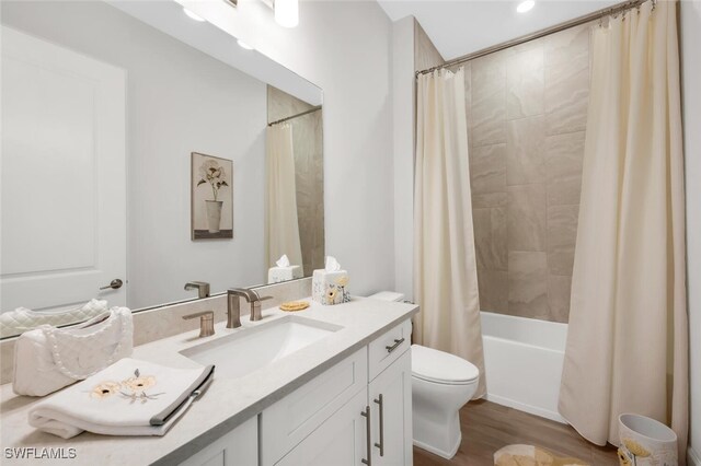 15766 Cortina St, Naples, FL 34114 - bathroom featuring vanity, toilet, shower / bath combo with shower curtain, and wood finished floors