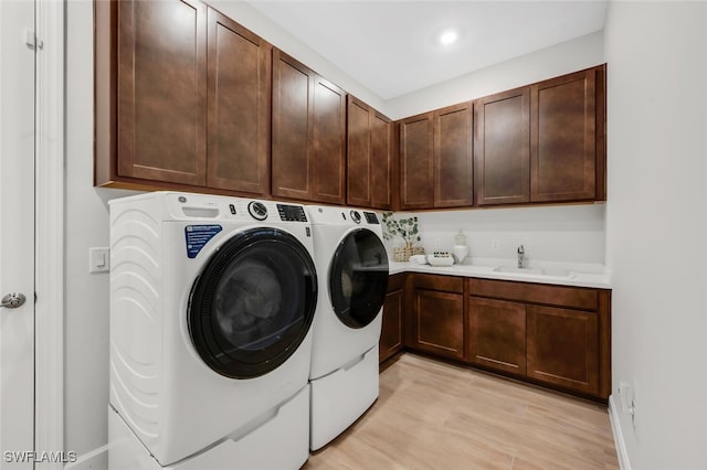 15766 Cortina St, Naples, FL 34114 - washroom featuring cabinet space, separate washer and dryer, light wood-type flooring, and recessed lighting
