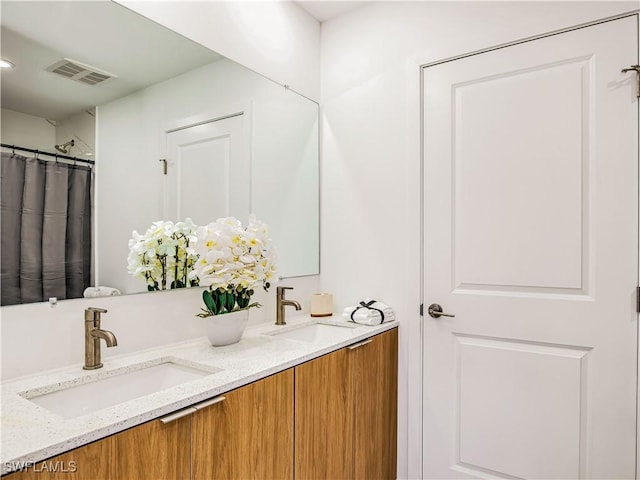 809 Bell Blvd S, Lehigh Acres, FL 33974 - bathroom featuring a sink, visible vents, and double vanity