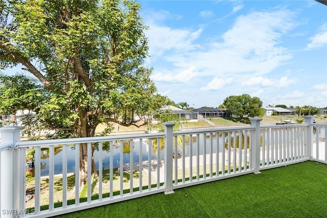 view of yard with a water view, a balcony, and a residential view