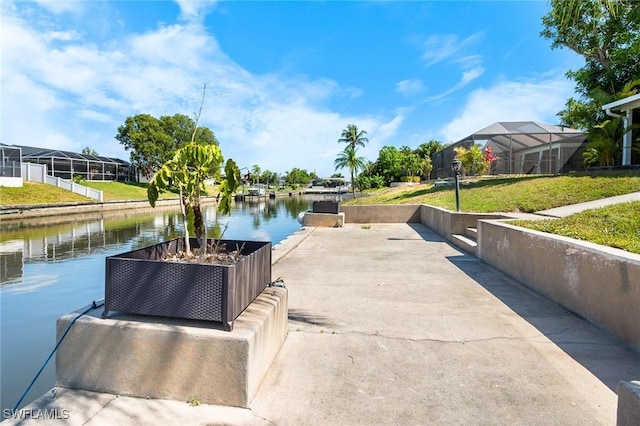 dock area with a water view and a yard