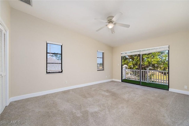 empty room featuring carpet floors, a ceiling fan, baseboards, and a wealth of natural light