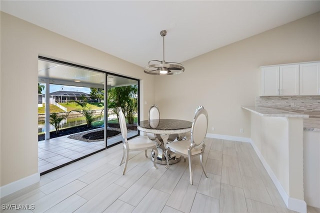 dining room featuring baseboards and a chandelier