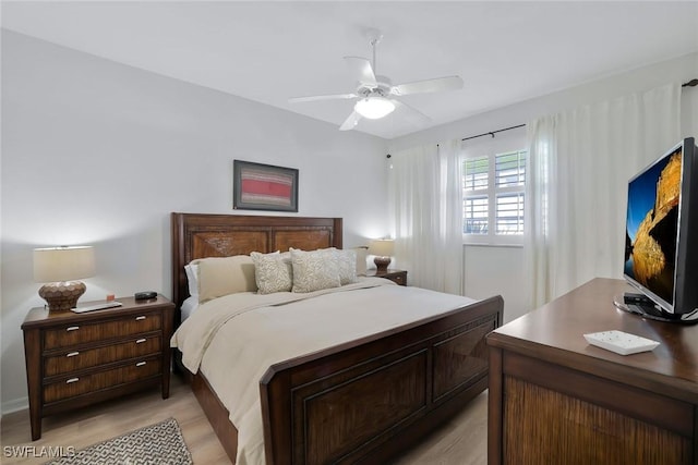 bedroom with ceiling fan and light wood-style flooring