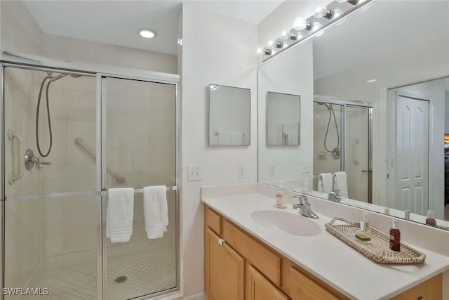 full bathroom featuring vanity and a shower stall