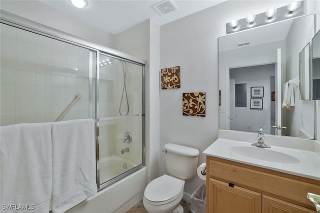 full bathroom with visible vents, toilet, shower / bath combination with glass door, and vanity