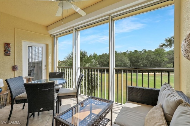 sunroom featuring outdoor dining space and ceiling fan