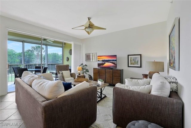 living area with light tile patterned floors and ceiling fan