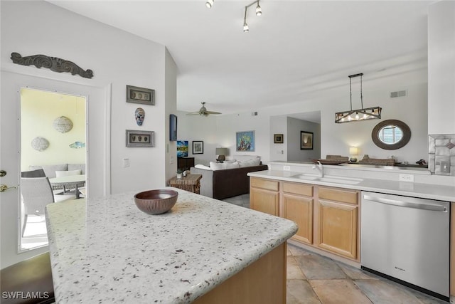 kitchen featuring a sink, visible vents, light countertops, stainless steel dishwasher, and open floor plan