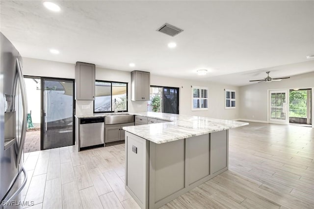 kitchen featuring visible vents, appliances with stainless steel finishes, a healthy amount of sunlight, and gray cabinetry