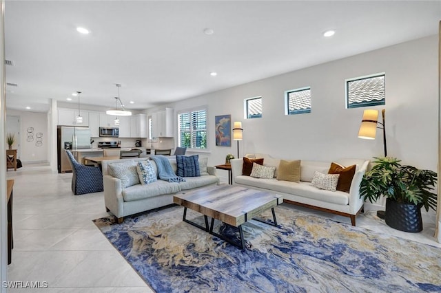 living room featuring light tile patterned floors and recessed lighting