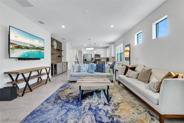 living area featuring beverage cooler, visible vents, and recessed lighting