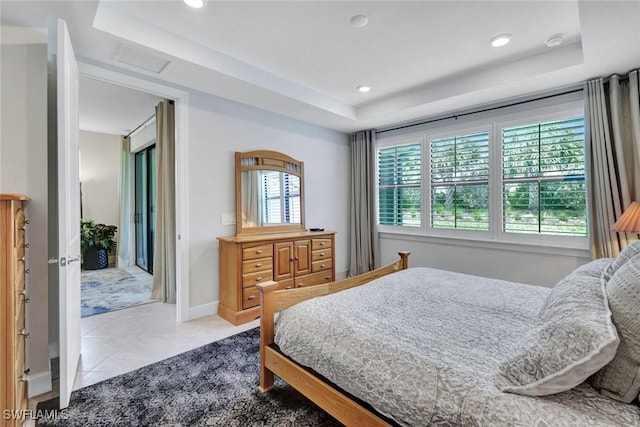tiled bedroom with attic access, baseboards, recessed lighting, and a raised ceiling