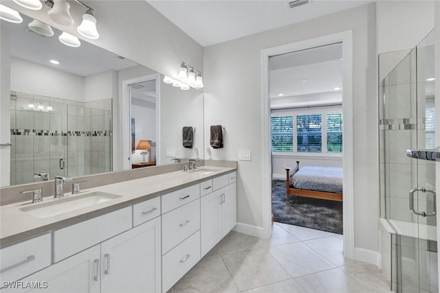 ensuite bathroom featuring baseboards, ensuite bath, and a sink