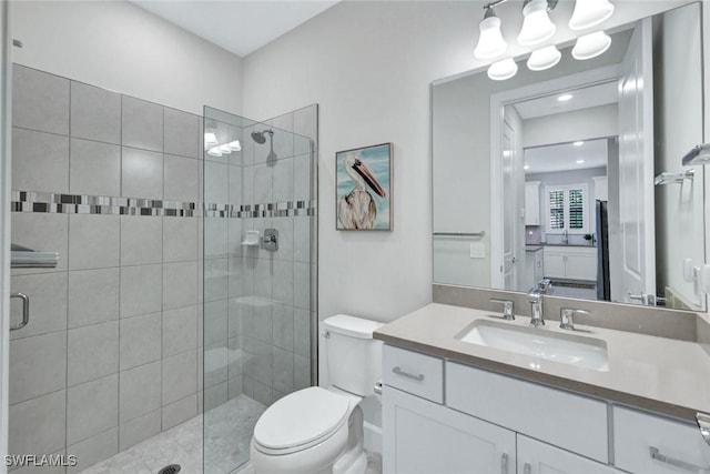 full bath featuring toilet, vanity, and a stall shower
