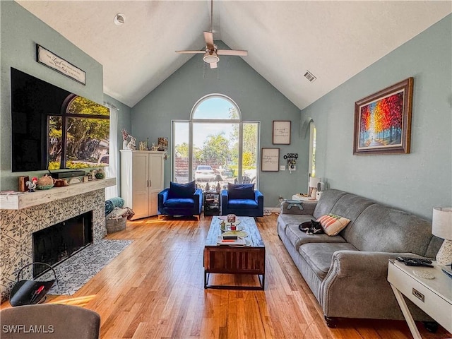 270 River Oaks Dr, Labelle, FL 33935 - living room with high vaulted ceiling, a ceiling fan, wood finished floors, a high end fireplace, and arched walkways