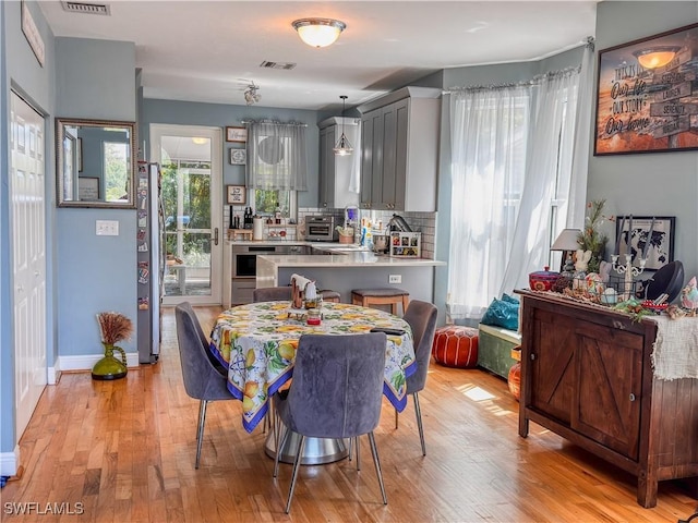 270 River Oaks Dr, Labelle, FL 33935 - dining space with light wood finished floors, visible vents, a toaster, and a healthy amount of sunlight