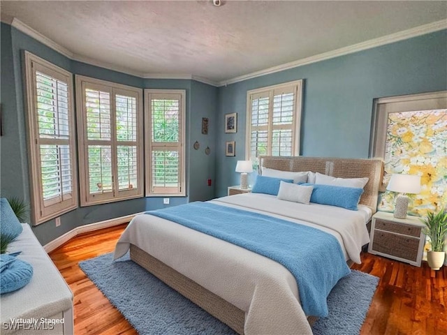270 River Oaks Dr, Labelle, FL 33935 - bedroom with baseboards, wood finished floors, and crown molding