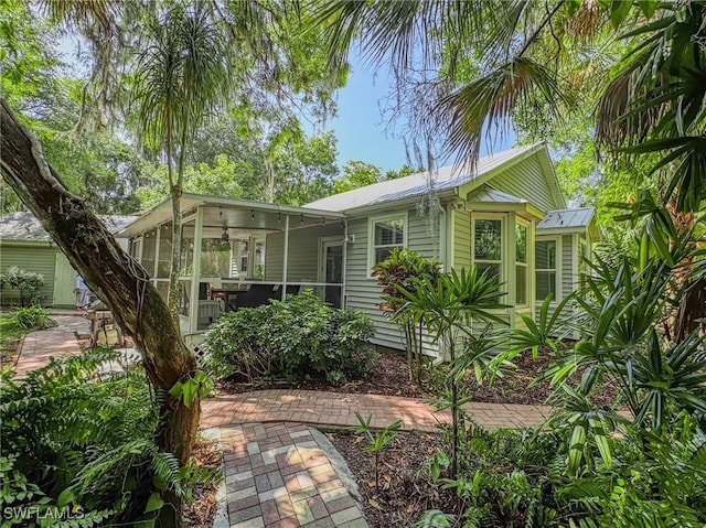 270 River Oaks Dr, Labelle, FL 33935 - view of front of property featuring a sunroom and metal roof
