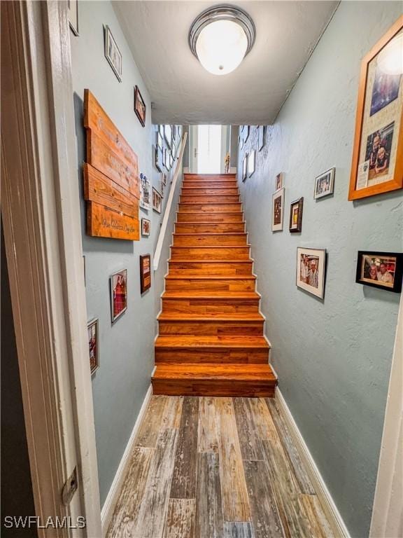 270 River Oaks Dr, Labelle, FL 33935 - stairway featuring baseboards and wood finished floors