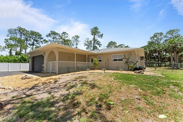 view of front of home with a garage, stucco siding, and concrete driveway