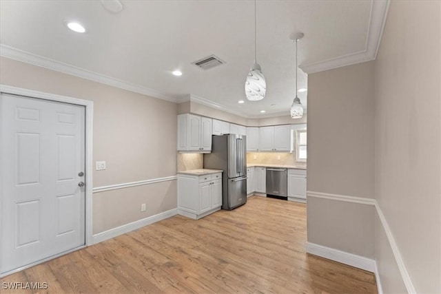 kitchen with stainless steel appliances, light countertops, baseboards, light wood-style flooring, and ornamental molding