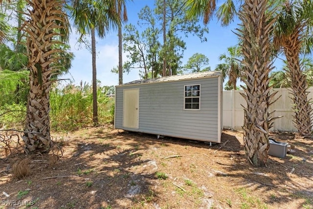 view of shed with fence