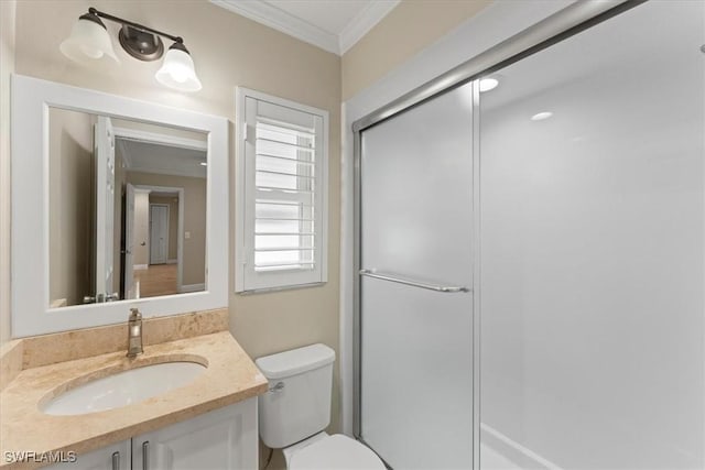bathroom featuring toilet, a shower stall, crown molding, and vanity