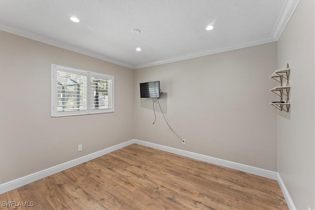 empty room with crown molding, baseboards, recessed lighting, and light wood-style floors