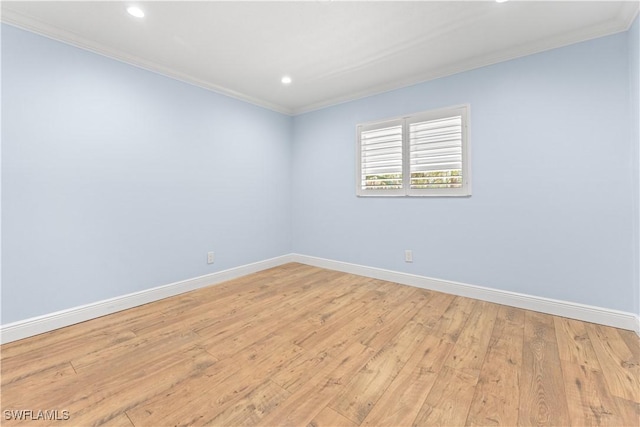 spare room featuring ornamental molding, baseboards, light wood-style floors, and recessed lighting