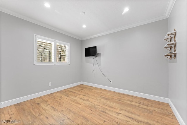 empty room featuring crown molding, light wood finished floors, baseboards, and recessed lighting