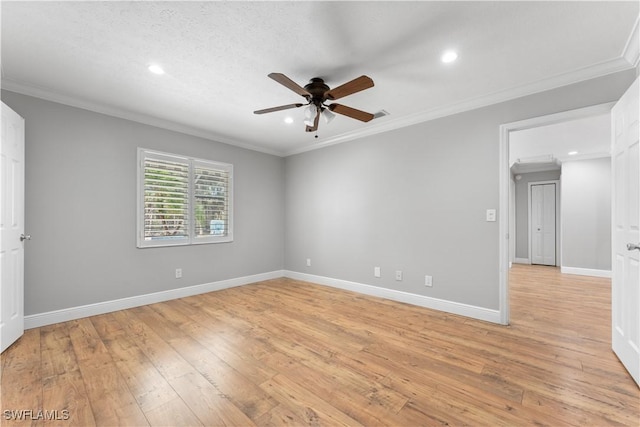 spare room with a ceiling fan, ornamental molding, light wood-style flooring, recessed lighting, and baseboards