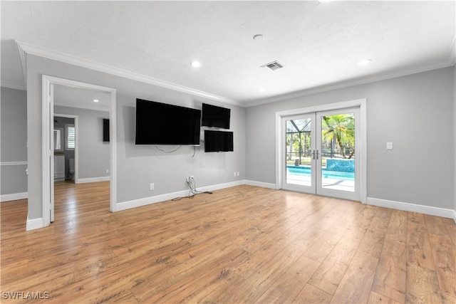 unfurnished living room with crown molding, french doors, plenty of natural light, light wood-style floors, and baseboards
