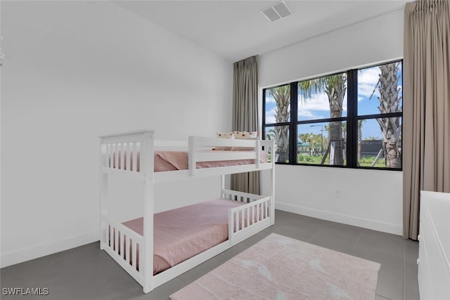 bedroom featuring visible vents, baseboards, and tile patterned flooring