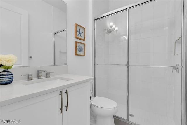 full bath featuring vanity, toilet, and a shower stall
