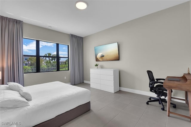 bedroom featuring baseboards and tile patterned floors