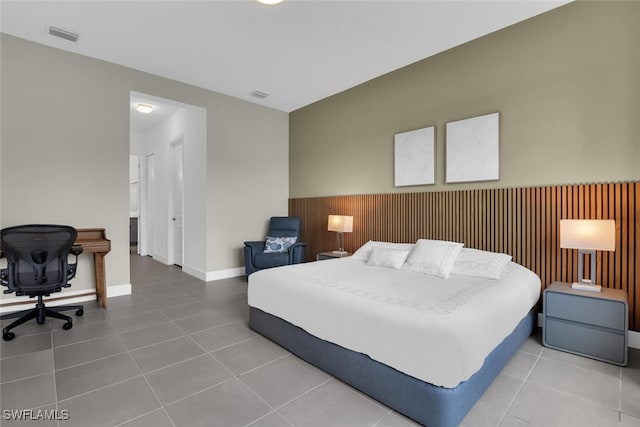 tiled bedroom featuring baseboards and visible vents