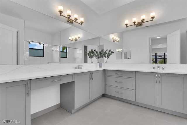 full bathroom with a walk in shower, tile patterned flooring, vanity, and a wealth of natural light