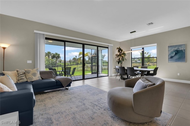 tiled living room featuring baseboards and visible vents