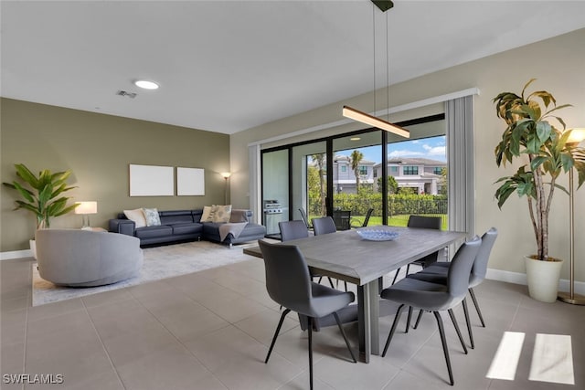 tiled dining area featuring visible vents and baseboards