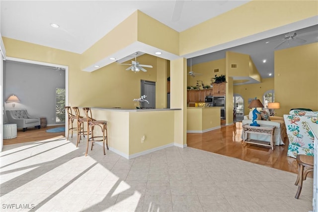 21075 Saint Peters Dr S, Fort Myers Beach, FL 33931 - kitchen with a ceiling fan, open floor plan, light tile patterned floors, recessed lighting, and stainless steel double oven