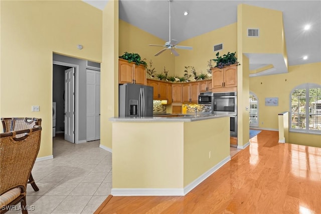 21075 Saint Peters Dr S, Fort Myers Beach, FL 33931 - kitchen with stainless steel appliances, high vaulted ceiling, a ceiling fan, baseboards, and a sink