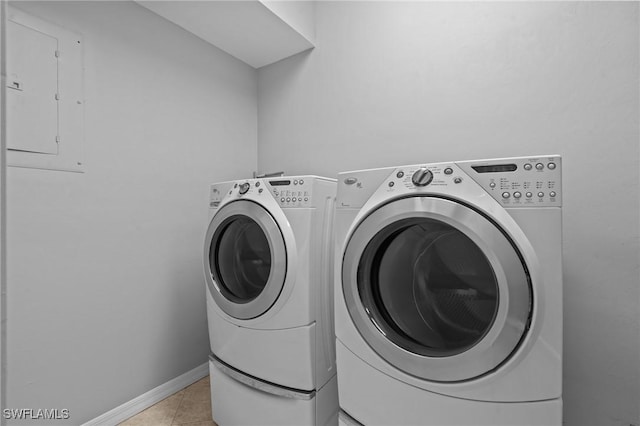 21075 Saint Peters Dr S, Fort Myers Beach, FL 33931 - laundry area with washer and dryer, light tile patterned floors, baseboards, and electric panel
