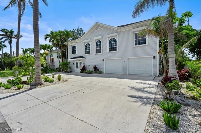 21075 Saint Peters Dr S, Fort Myers Beach, FL 33931 - view of front of house featuring an attached garage and concrete driveway